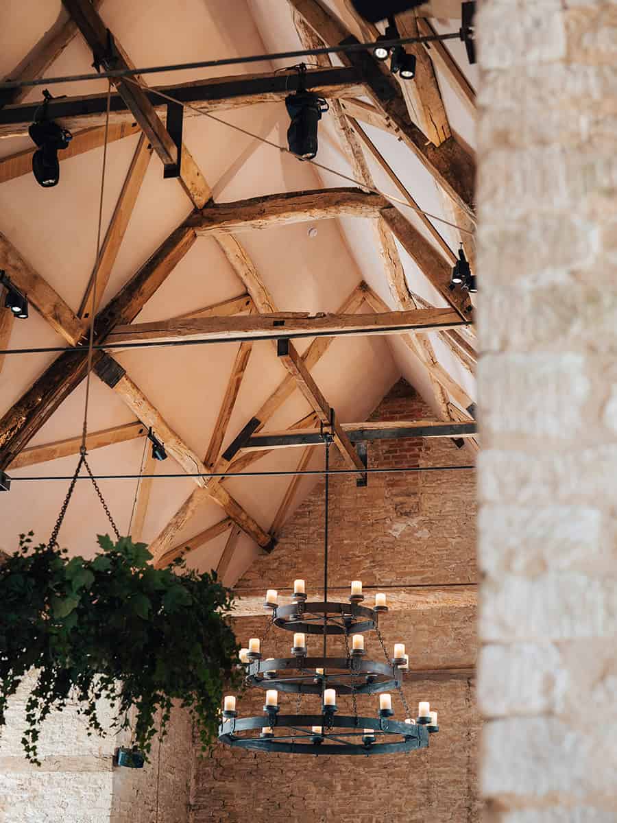 Ivy Lodge medieval oak roof structure with exposed timber trusses and iron chandelier, Cirencester Park